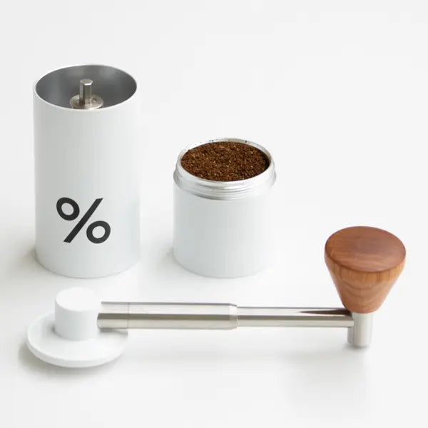 % ARABICA Travel Grinder. Aluminum Alloy, Stainless Steel, Natural Wood with carry bag. Compact and grinds up to 15 grams.